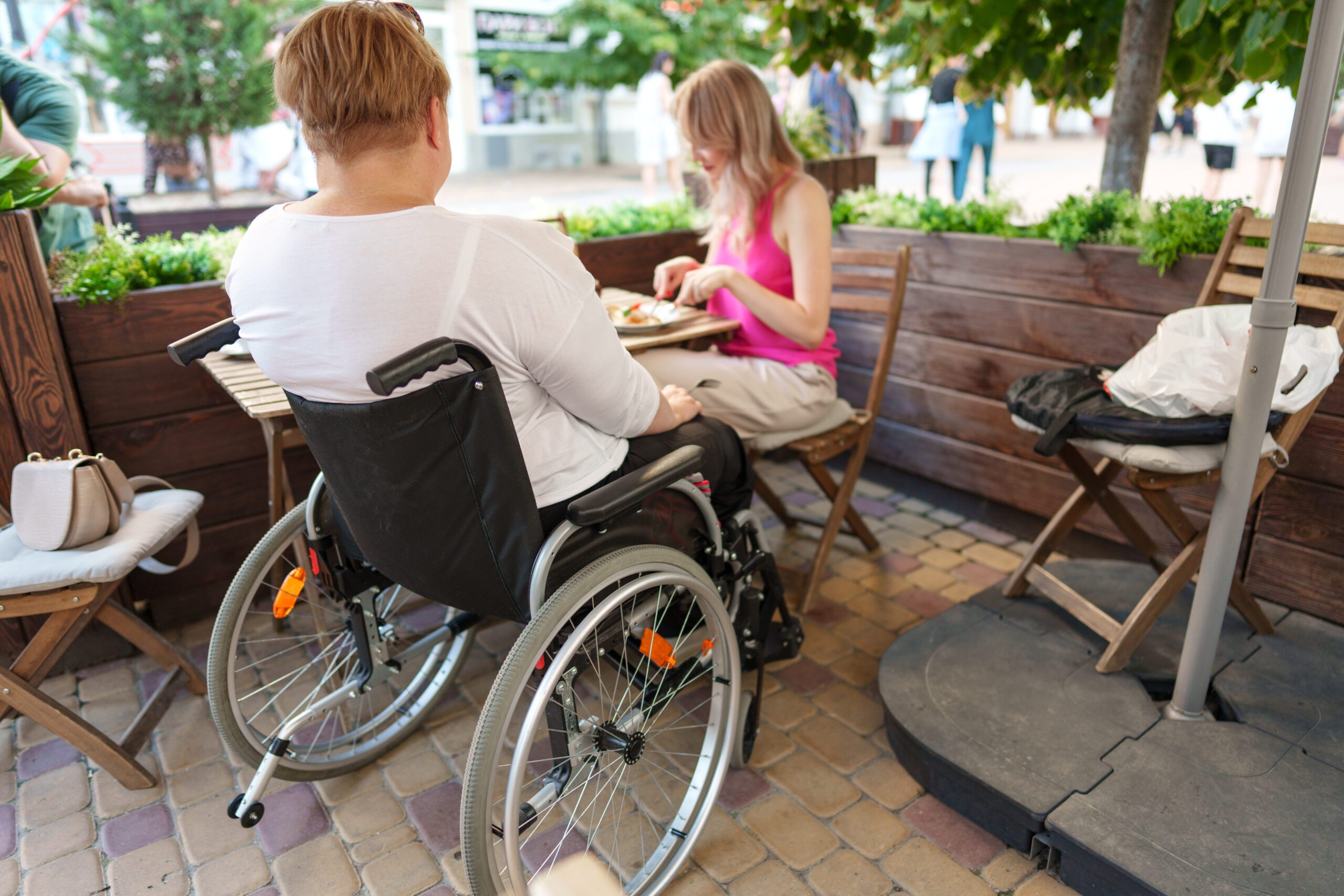 woman wheelchair user dining at a restaurant with 2022 11 09 05 15 22 utc scaled